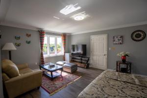 a living room with a couch and a table at Butterfly Manor in Niagara Falls