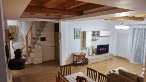 a living room with a couch and a table at Dua 1 Apartments Shkoder in Shkodër