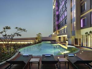 a swimming pool in the middle of a building at Mercure Karawang in Karawang