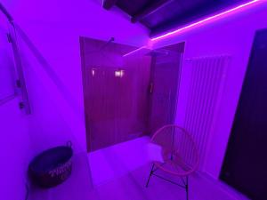 a pink room with a chair and a mirror at Gredò Home & SPA in Gratteri +25 photos