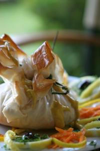 a plate of food with shrimp on top of it at Hotel Antonios in Olympia