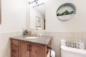 a bathroom with a sink and a mirror and a toilet at Vermont Mountain Chalet in Stratton +52 photos
