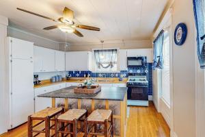 a kitchen with white cabinets and a ceiling fan at Maplewood Manor in Colchester
