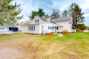 a white house with a large yard at Maplewood Manor - Unit 1 in Colchester