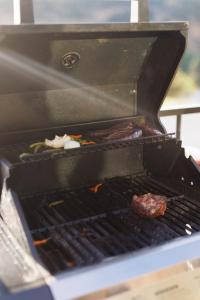 a grill with meat and vegetables on it at Iron Cliff in Orderville