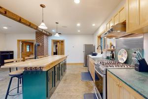 a large kitchen with wooden cabinets and a counter top at Meet Me At Our Spot in Moretown