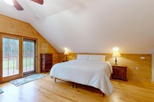 a bedroom with a bed and a large window at Meet Me At Our Spot in Moretown