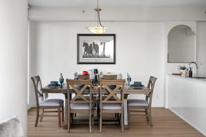 a dining room with a table and chairs at Nuage 2 Bed 2 Bath 2 Balconies Parking in Calgary