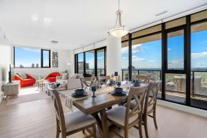a dining room and living room with a table and chairs at Nuage 2 Bed 2 Bath 2 Balconies Parking in Calgary