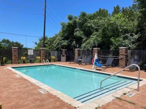 a swimming pool with a swing in a yard at City Express by Marriott Spring North Houston in Spring