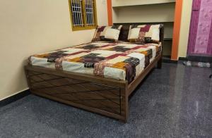 a bedroom with a bed in a room at Fantasy Homestay in Thiruchendur