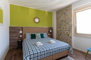 a bedroom with a bed with a green wall at Ledro Lake Suites in Ledro