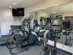 a gym with treadmills and ellipticals in front of a mirror at City Express by Marriott Spring North Houston in Spring +21 photos