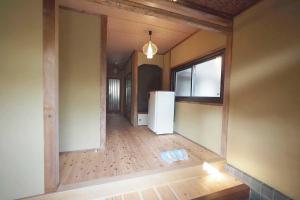 an empty room with a refrigerator in a house at ライダーハウスみかさんち in Marugame +6 photos