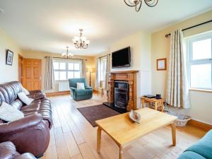 a living room with a couch and a fireplace at 4 Bed in Schull oc-ii09887 in Schull