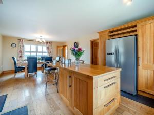 a kitchen with a refrigerator and a table with chairs at 4 Bed in Schull oc-ii09887 in Schull