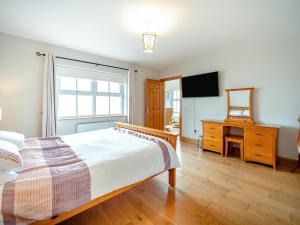 a bedroom with a bed and a desk and a television at 4 Bed in Schull oc-ii09887 in Schull