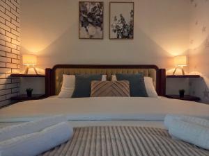 a bedroom with a large bed with two lamps at Piva Rustic Escape in Plužine