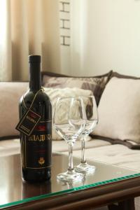 a bottle of wine and a wine glass on a table at Piva Rustic Escape in Plužine