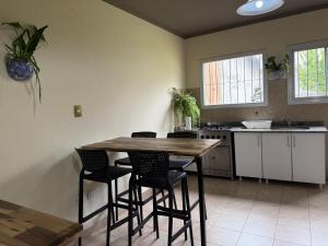 a kitchen with a wooden table and chairs at vivo alquilando - BROWN 340 in Salta