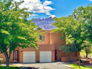 a house with two garage doors in front of a mountain at Solano Vallejo 3288 in Moab