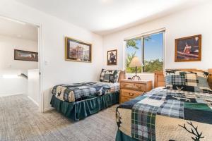 two beds in a room with a window at Solano Vallejo 3288 in Moab
