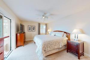 a bedroom with a bed and a ceiling fan at Malletts Bay Getaway in Colchester +48 photos