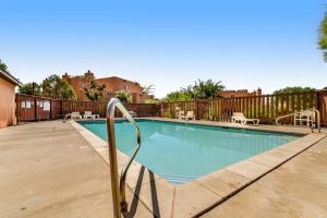 a swimming pool with a metal railing next to a fence at Solano Vallejo 3288 in Moab
