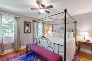 a bedroom with a canopy bed and a ceiling fan at The Worden House in Manchester