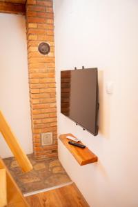 a flat screen tv hanging on a wall at Vikendica Vinogradski Mir, Jacuzzi and Vineyard View in Bačinci
