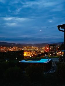 a view of a city at night at Cozy Cabin House in Novi Pazar