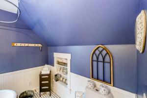 a bathroom with a blue ceiling and a toilet at Cozy Modern Farmhouse in Wallingford +53 photos