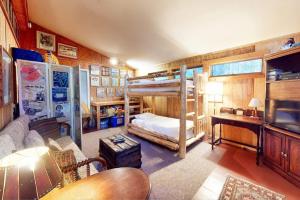 a room with two bunk beds and a couch at Walk to the Lakes in Ludlow