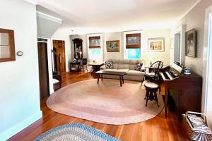 a living room with a couch and a table at Walk to the Lakes in Ludlow
