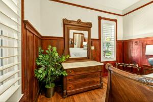 a room with a mirror and a dresser with a plant at Whimsy on B- 2BR & Studio Near OSF in Ashland +46 photos