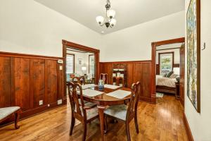 a dining room with a table and chairs and a bedroom at Whimsy on B- 2BR & Studio Near OSF in Ashland
