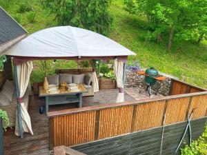 a gazebo with a couch on a wooden deck at Kelgumäe in Otepää