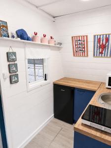 a kitchen with white walls and a counter and a sink at Domek letniskowy Keja in Skorochow