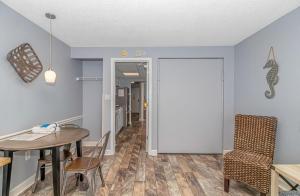a dining room with a table and a chair at Boardwalk 1030 in Myrtle Beach