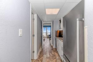 a hallway leading to a kitchen with a view of the ocean at Boardwalk 1030 in Myrtle Beach