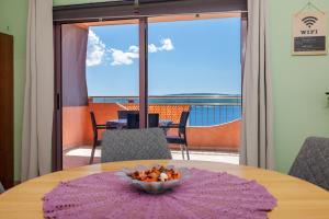 a table with a bowl of food on top of it at Apartments Djusi in Dramalj
