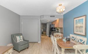 a living room with a table and a dining room at Atlantica 1055 in Myrtle Beach