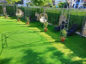a garden with potted plants and a fence at Villa Cultural MONTELUCÍA in Montecorto