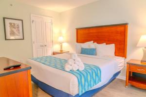 a hotel room with a bed with two towels on it at Sandy Beach 1612 in Myrtle Beach