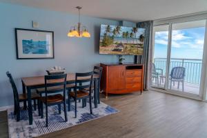 a dining room with a table and chairs and a balcony at Sandy Beach 1612 in Myrtle Beach +59 photos