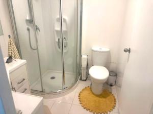a white bathroom with a shower and a toilet at Private 2-Bedroom Suite in 3-Bedroom House in Auckland +15 photos