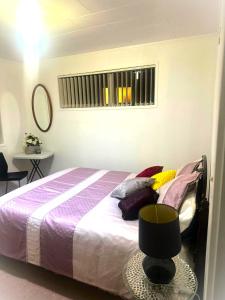 a bedroom with a bed with a table and a window at Private 2-Bedroom Suite in 3-Bedroom House in Auckland
