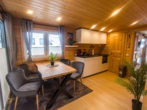 a kitchen and dining room with a table and chairs at Haus am See Thermal Bad Saarow in Bad Saarow