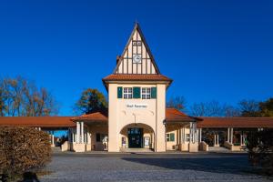 a building with a tower with a clock on it at Haus am See Thermal Bad Saarow in Bad Saarow
