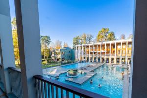 a view from a balcony of a swimming pool at Haus am See Thermal Bad Saarow in Bad Saarow